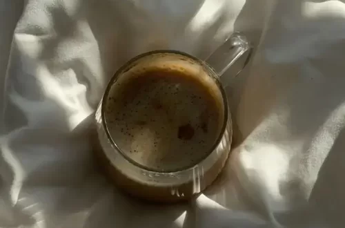 Cup of Coffe on a Bed