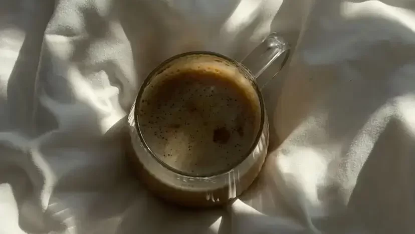Cup of Coffe on a Bed